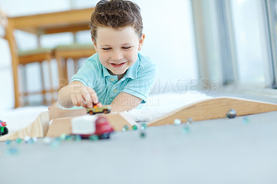 Buy stock photo Toys, cars or kid in home playing for learning, development and fun with smile or activity. Excited, boy or child enjoying games with plastic vehicle for childhood hobby or growth at house in England