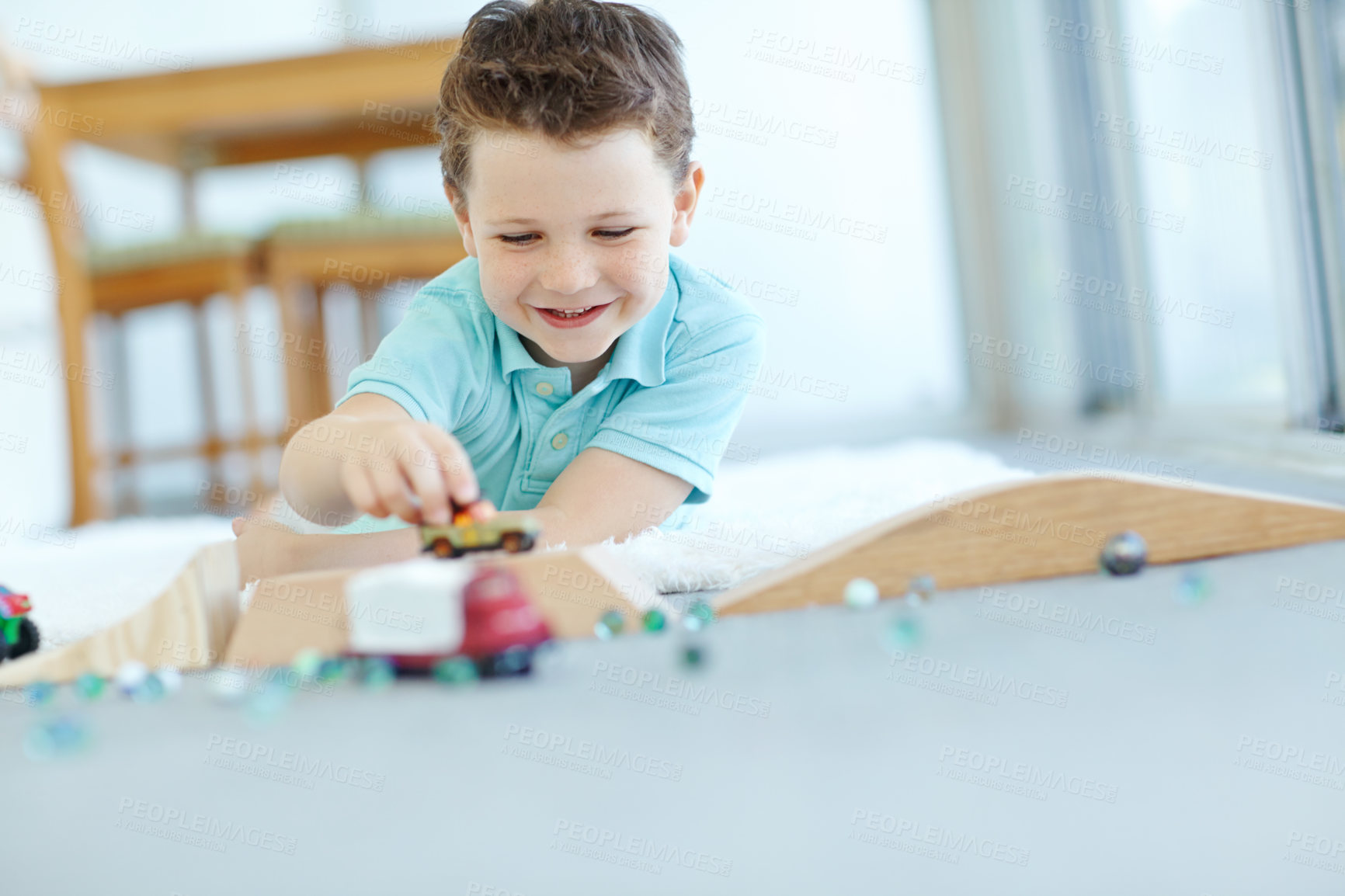 Buy stock photo Toys, cars or kid in home playing for learning, development and fun with smile or activity. Excited, boy or child enjoying games with plastic vehicle for childhood hobby or growth at house in England