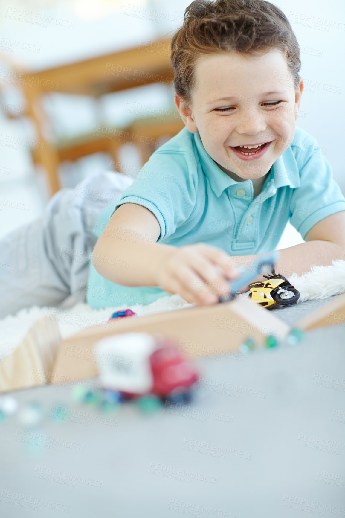 Buy stock photo Excited, cars or boy laughing with toys for learning, development and fun with smile. Playing, child or happy kid enjoying games with plastic vehicle for childhood hobby or growth at house in England