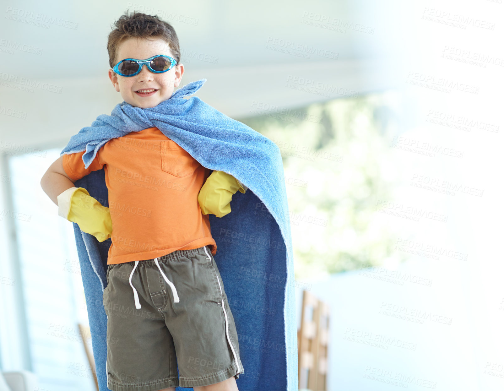 Buy stock photo Portrait, confident kid and happy superhero in home for funny game, fantasy or play. Smile, cute boy and fearless hero with cape or costume to fight for justice, power or creative cosplay in lounge