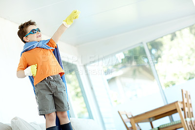 Buy stock photo Kid, boy or superhero costume in home with fantasy game, playing or pretend character with smile. Person, power and action fist with imagination for child development, adventure or halloween in house