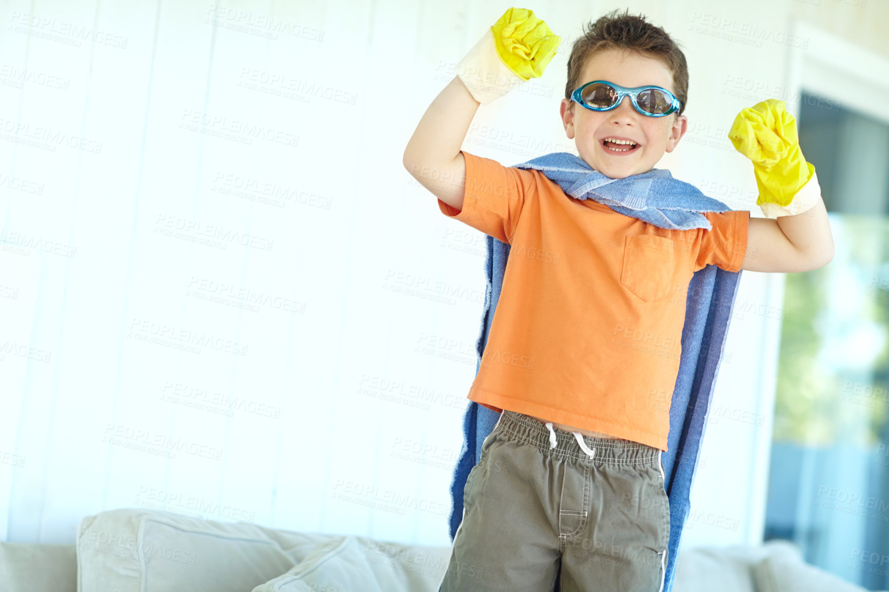 Buy stock photo Excited, kid and happy superhero in home to play fantasy game, laugh or celebrate. Smile, cute boy and funny hero with costume to fight for justice, power or creative cosplay in lounge on halloween