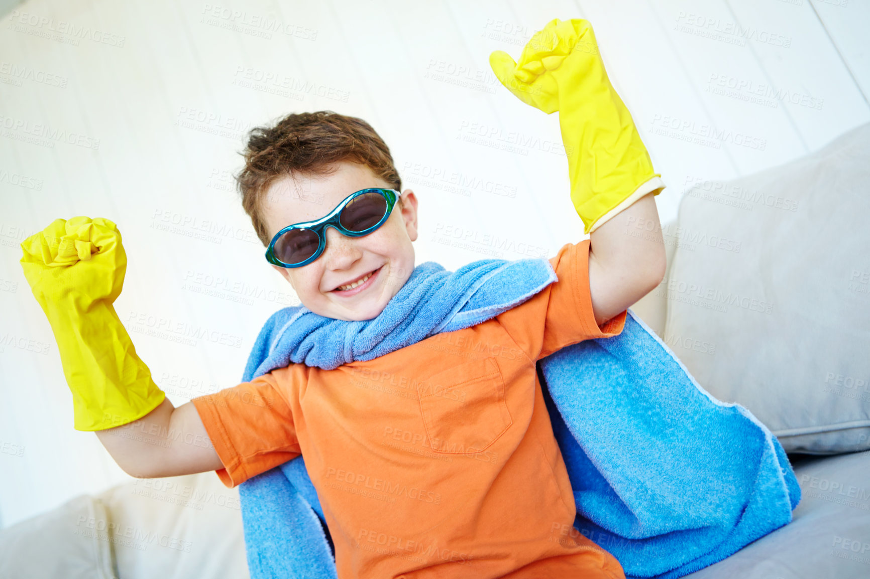 Buy stock photo Flex muscle, kid and happy superhero in home to play fantasy game. Face, cute boy and strong hero with power in cosplay costume to fight for justice, courage or confident in living room on halloween