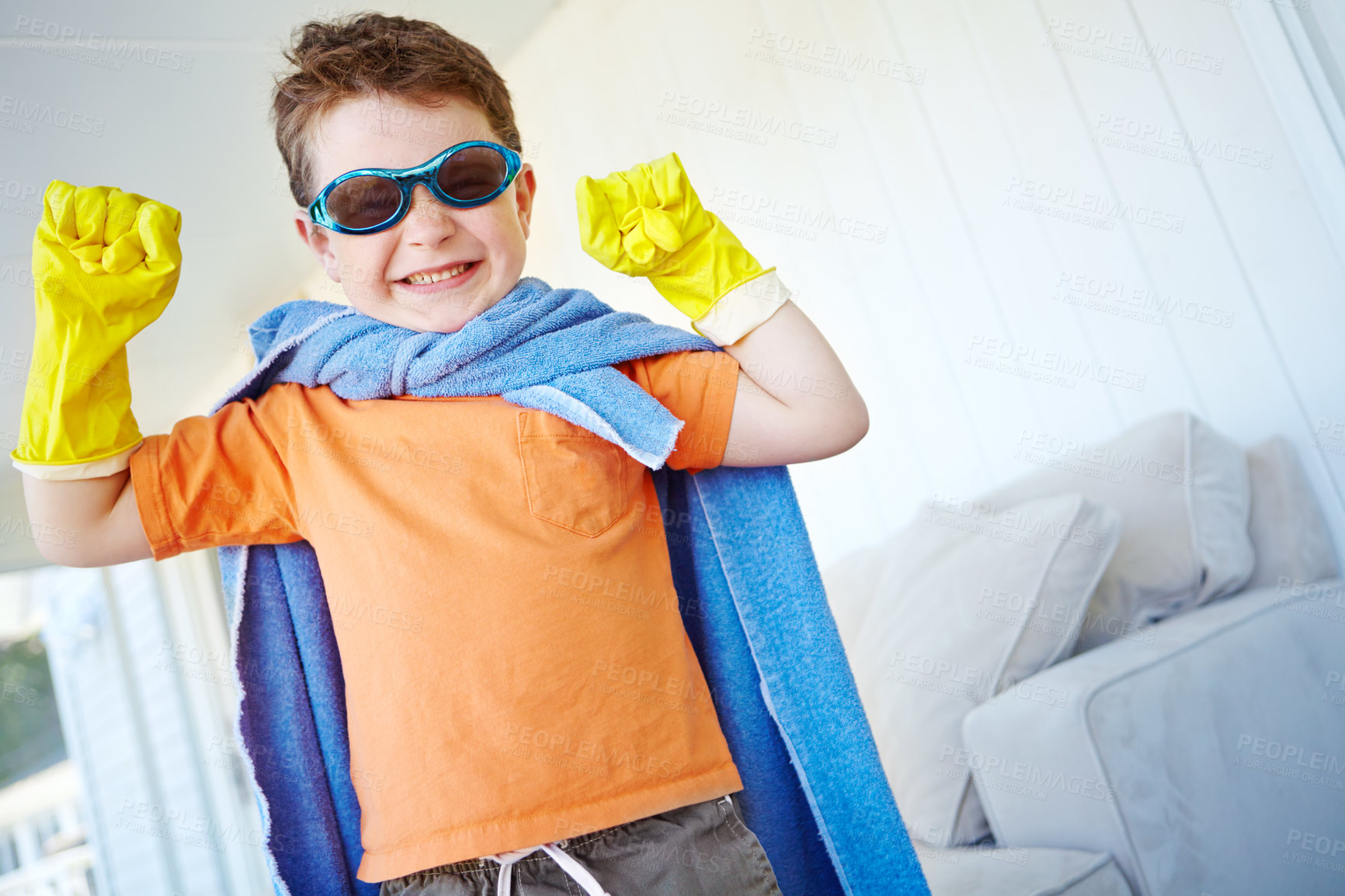 Buy stock photo Strong, child and smile of superhero in home to play fantasy game on halloween. Happy, cute boy or hero with power in creative costume to fight for justice, confident and flex muscle in living room