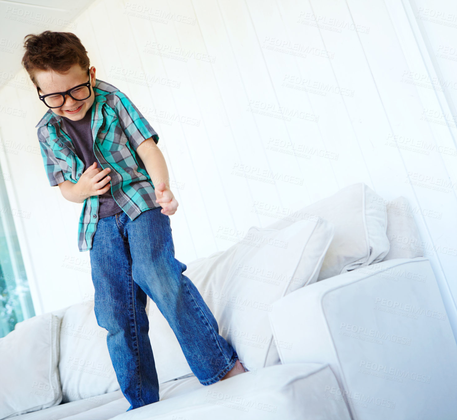 Buy stock photo Dancing, happy or boy with air guitar on sofa for comedy, humour or funny joke for artistic expression. Excited, music or crazy child playing with celebration or imaginary instrument on couch in home