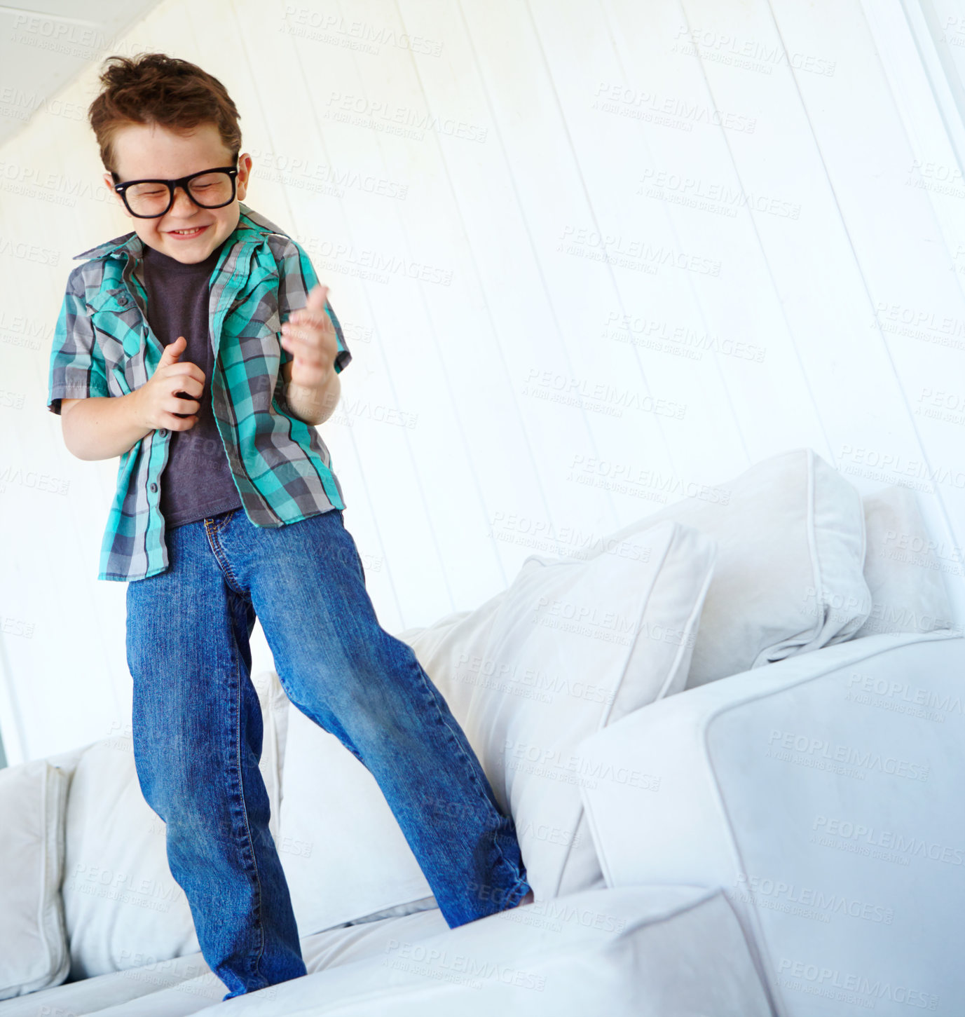 Buy stock photo Dance, excited or kid with air guitar on sofa for comedy, humour or funny joke for rock and roll. Happy, music or crazy boy child playing with celebration or imaginary instrument on couch in home