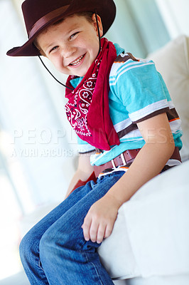 Buy stock photo Portrait, cowboy or child with smile in home, childhood and dress up for halloween concert in living room. House, happy kid and fantasy with fashion for character role, cosplay and confident in Texas