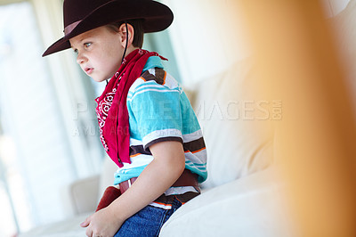 Buy stock photo Home, cowboy or child for fashion with character, childhood and dress up for halloween concert. House, serious kid and fantasy theme with vintage style for role development, cosplay and pride on sofa