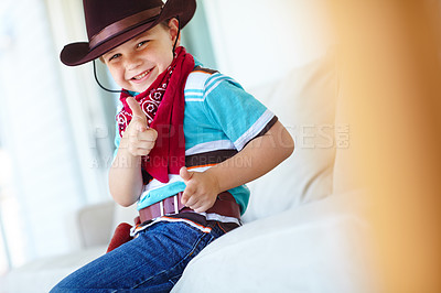 Buy stock photo Kid, boy and portrait with cowboy costume in home for fantasy play, shooting game or pointing pretend gun. Person, smile or hand gesture on sofa for halloween, dress up or protection with imagination