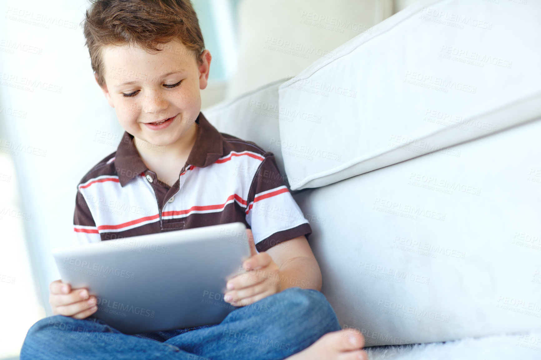 Buy stock photo Happy child, tablet and relax in home, reading ebook and watch cartoon on living room floor. Boy, kid and digital technology for internet addiction, scroll app or playing game for education on carpet