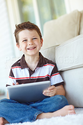 Buy stock photo Portrait, tablet and happy kid relax in home for learning on living room floor. Boy, child and digital technology for internet addiction, scroll app or playing game for education on carpet in Germany