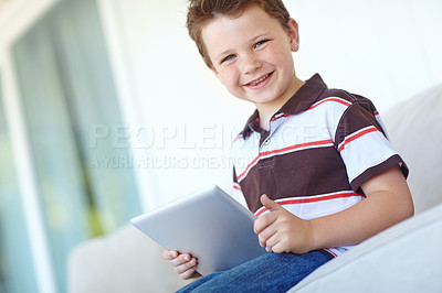 Buy stock photo Portrait, tablet and happy child in home for learning on sofa in living room in Canada. Face, smile and boy kid with digital technology for internet, scroll app or playing game for education in house