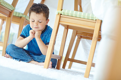 Buy stock photo Boy, child and praying in home, religion and dining room fort for innocent faith or Christianity. Male person, kid and cloth tent to worship or praise God, thank you Jesus Christ and floor for belief