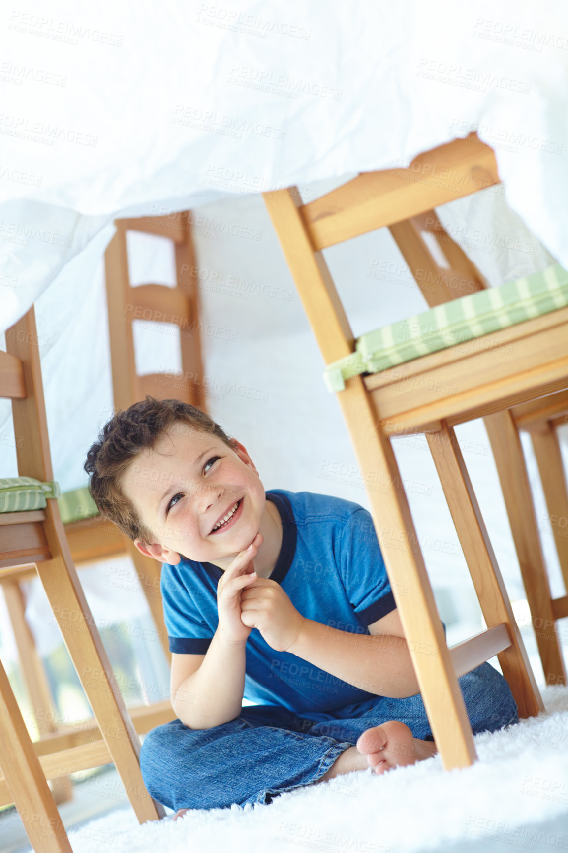 Buy stock photo Home, child and smile with duvet for playing, entertainment and imaginative game for childhood by carpet. House, young boy and happiness with thinking for fantasy, hide and seek in family apartment