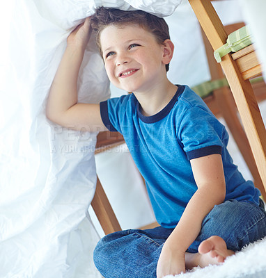 Buy stock photo Home, boy and laughing with duvet for playing, entertainment and imaginative game for childhood. House, happy child and comforter as shield for fantasy, hide and seek in family apartment on carpet