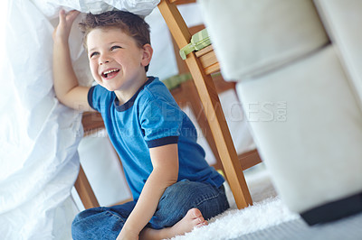 Buy stock photo Home, boy and smile with duvet for playing, entertainment and imaginative game for childhood. House, happy child and comforter as shield for fantasy, hide and seek with laughing in lounge by carpet