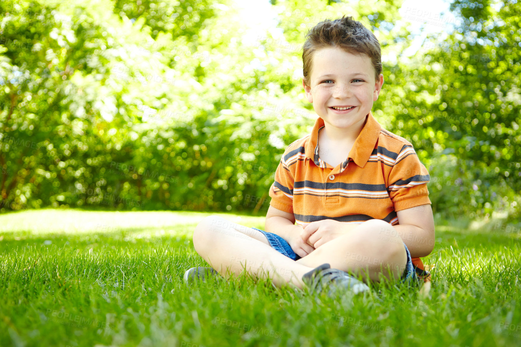 Buy stock photo Boy, child and outdoor portrait on grass, forest adventure and countryside meadow for development. Male person, happy kid and travel to France for exploring, relax and healthy growth in environment