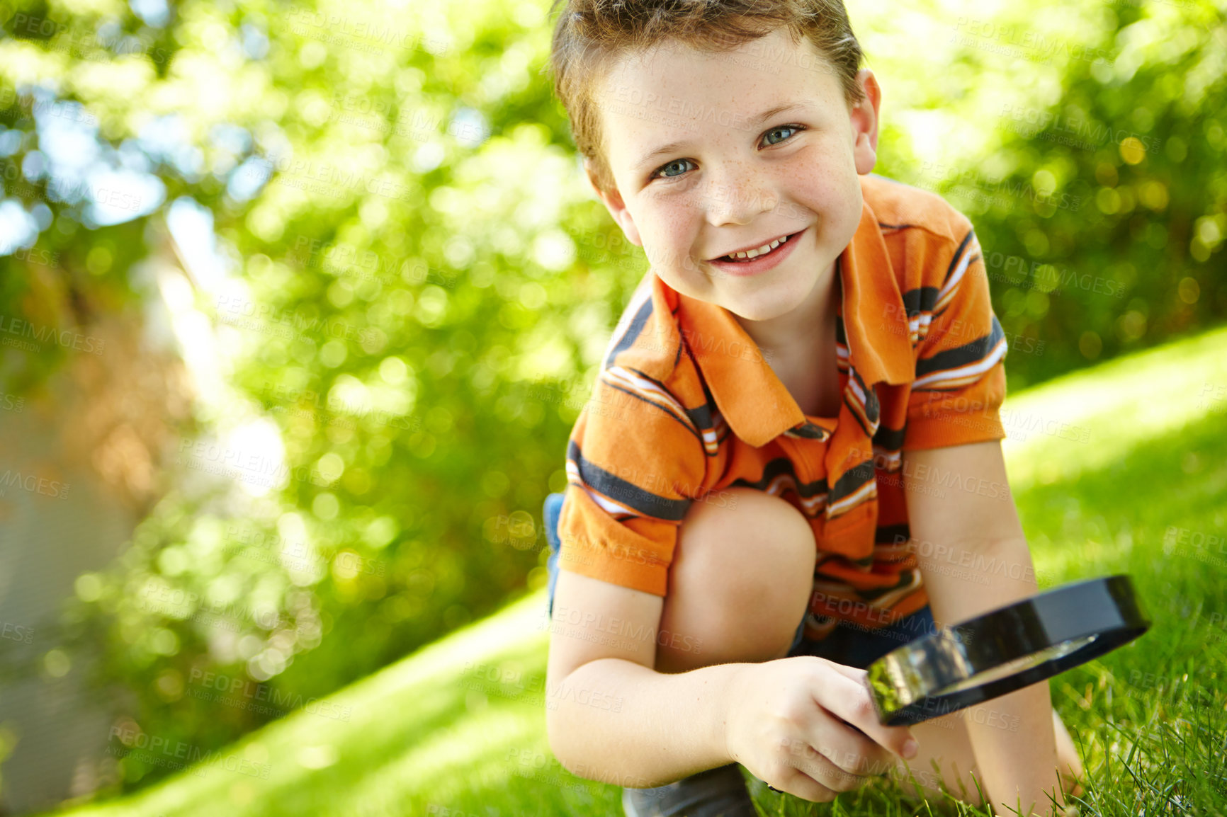 Buy stock photo Outdoor, child and portrait with magnifying glass for grass, observe ecology and learning nature with smile. Backyard, boy and curiosity with tool for discovery, studying biology and plants knowledge