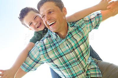 Buy stock photo Father, son and sky with fly on piggyback for fun, support and care outdoor in France. People, parent and smile with kid as family on break to play with love, trust and child development or growth