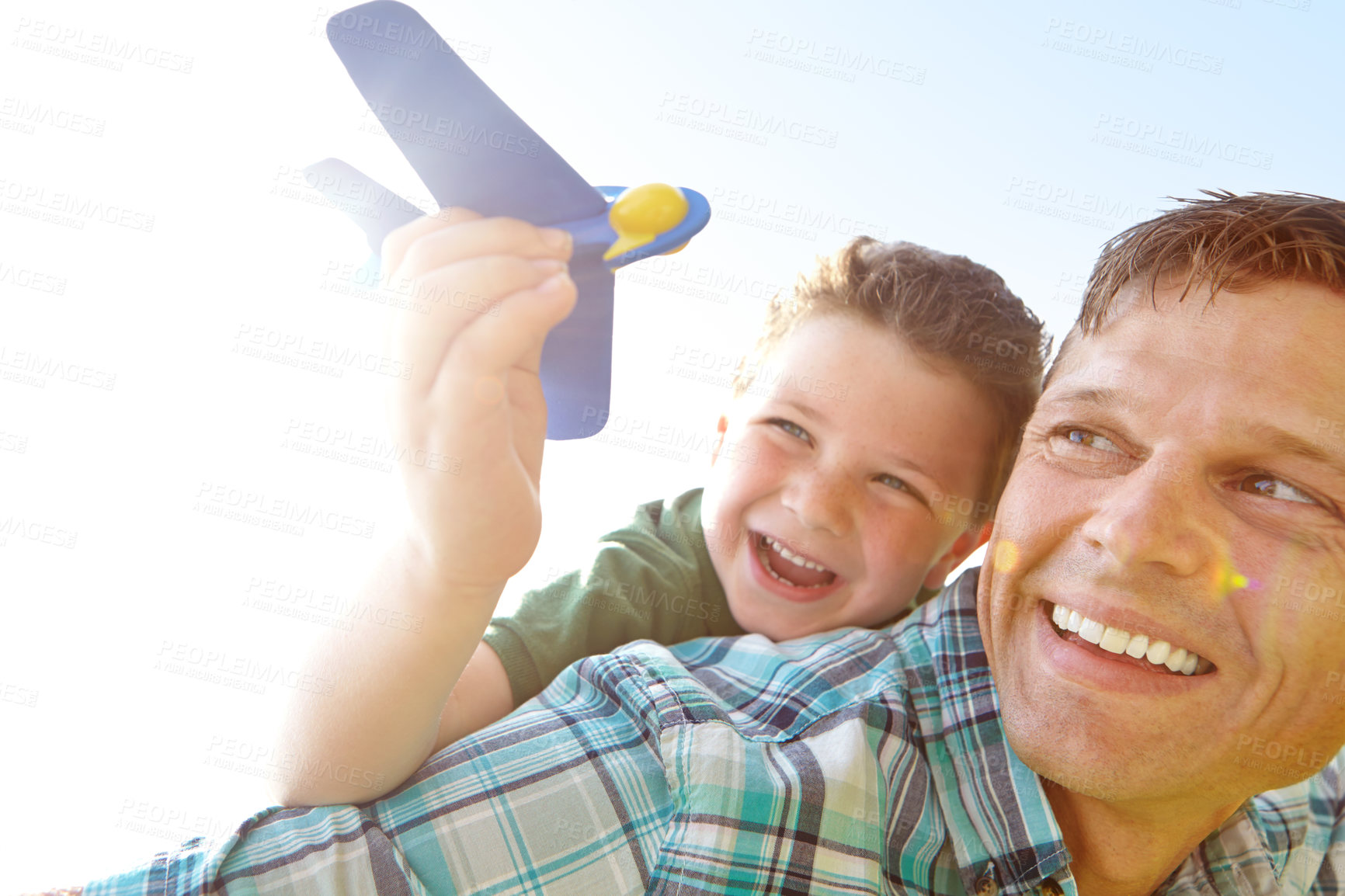 Buy stock photo Laughing, flying or toy with father and son outdoor together for bonding, comedy or having fun. Face, funny or plane with happy single parent man and boy child playing for fantasy or relationship