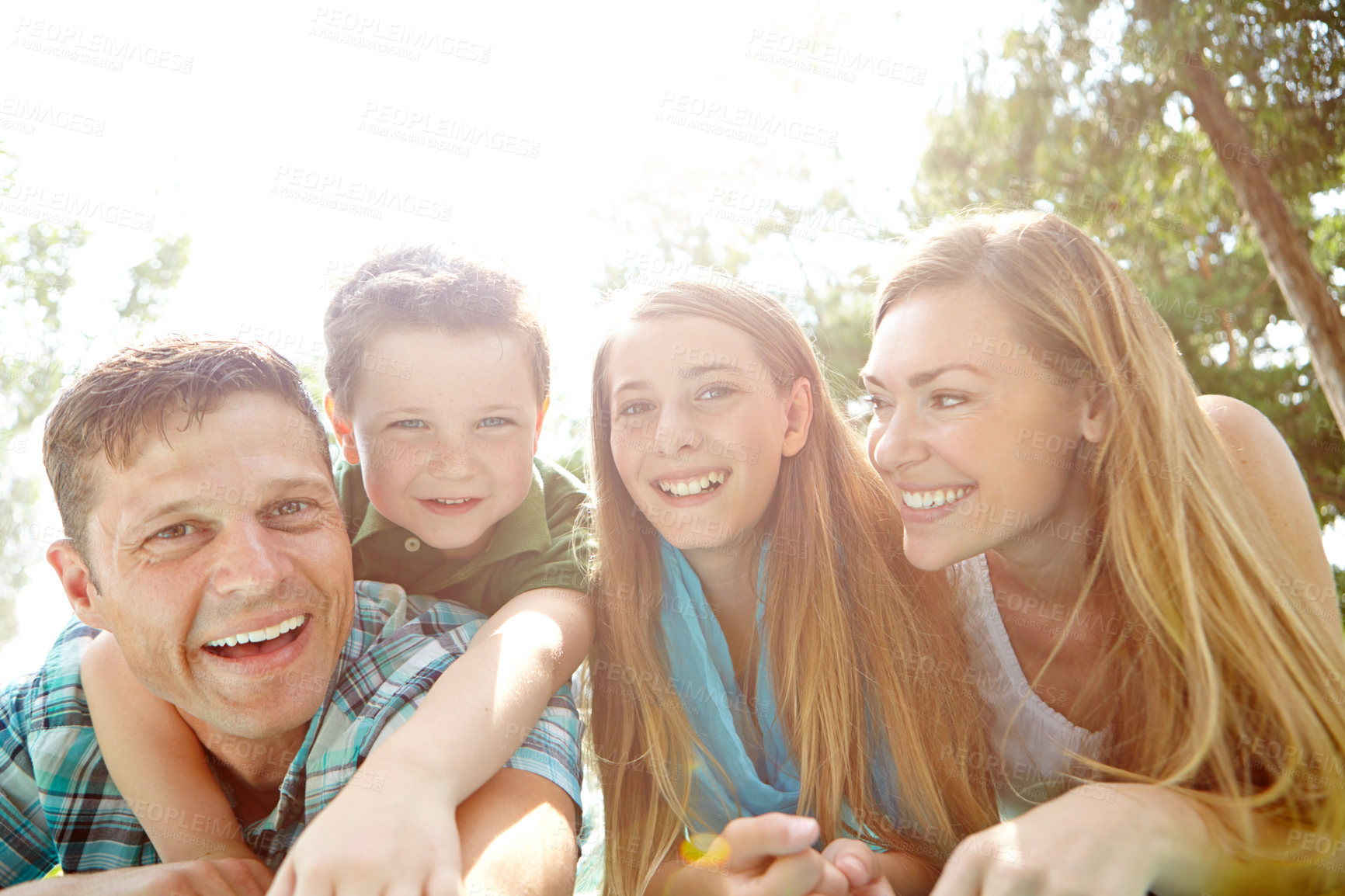 Buy stock photo Picnic, hug and portrait of family, nature and bonding with children, outdoor and parents in park. Embrace, mom and dad with kids, relax and break in weekend, happy and man with woman and together