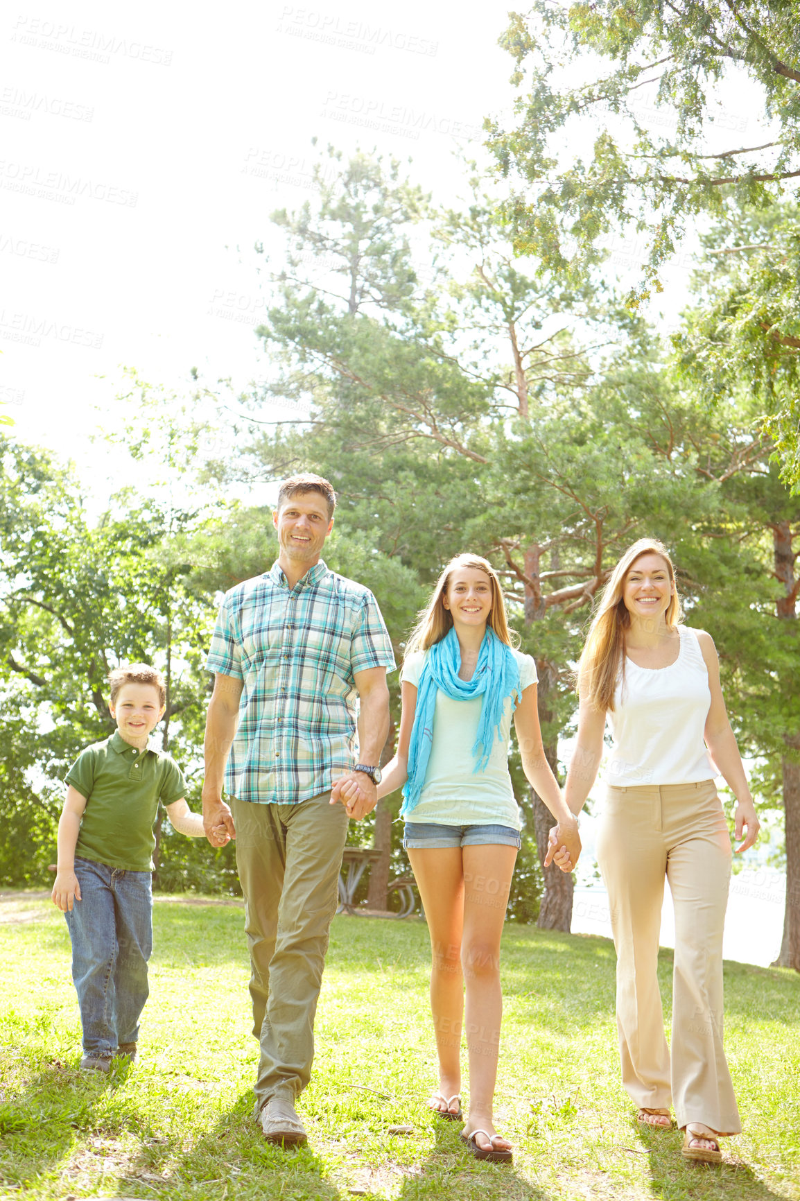 Buy stock photo Family, love and holding hands in park for portrait, trust or excited for adventure in Australia. Parents, children or gesture in nature for guidance, support and safety on holiday or summer vacation