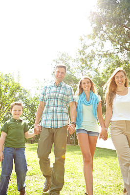 Buy stock photo Happy family, portrait and holding hands in park for trust, love and excited for adventure in Australia. Parents, children and gesture in nature for guidance, support and safety on summer vacation