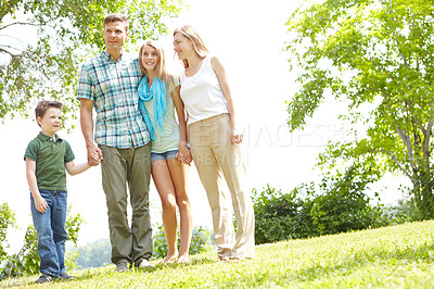 Buy stock photo Holding hands, happy family and parents with kids outdoor for holiday, vacation and people bonding. Smile, mother and father with children at park for love, support and care with siblings together