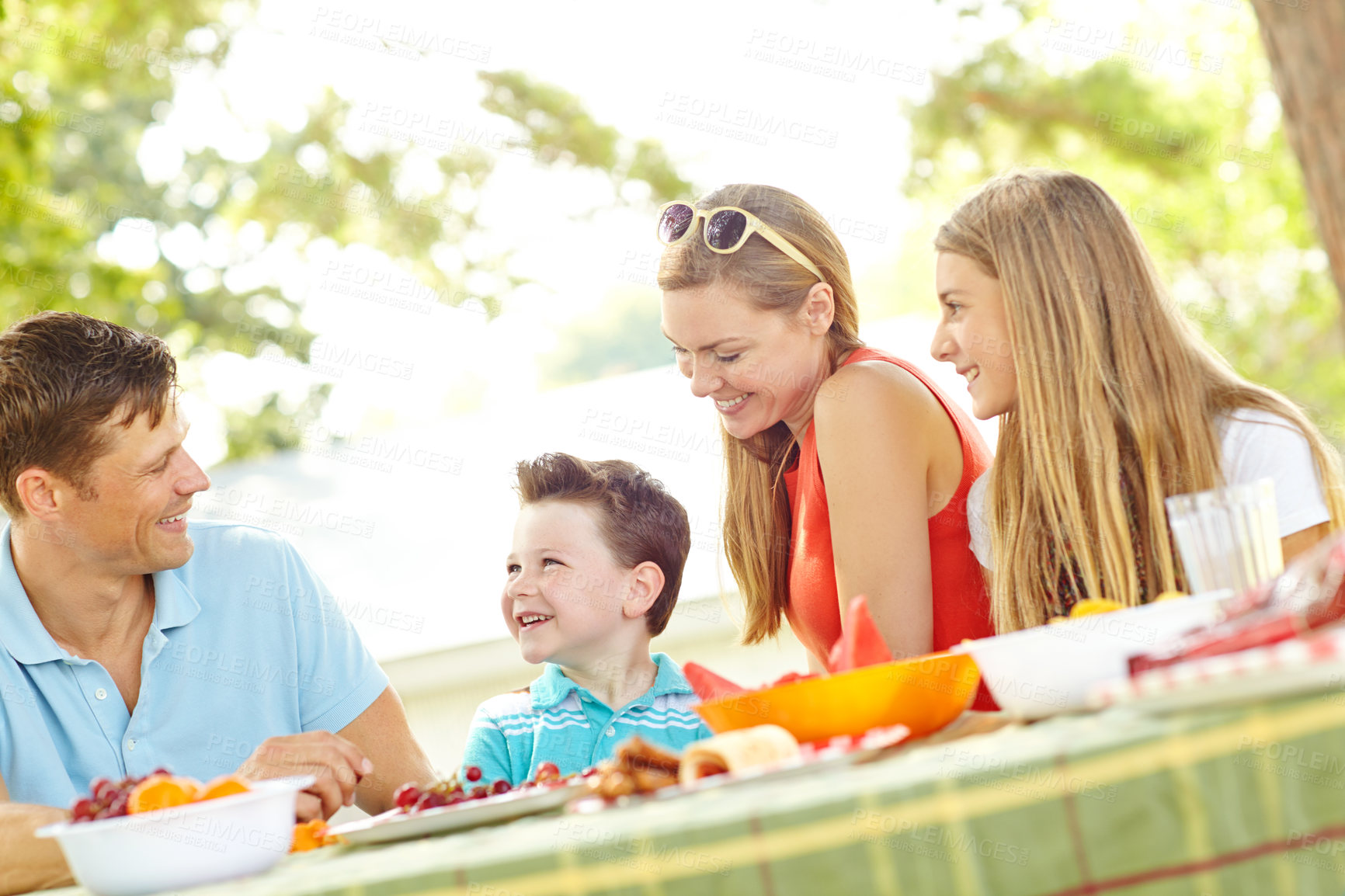 Buy stock photo Children, happy family and parents at picnic with food for party and eating fruits for thanksgiving. Smile, lunch and people together outdoor with mother, father and kids on holiday for celebration