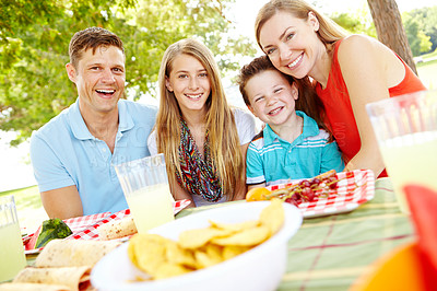 Buy stock photo Portrait, happy family and parents at picnic with food for party and eating at thanksgiving. Face, lunch and people outdoor with mother, father and kids for celebration on summer holiday together