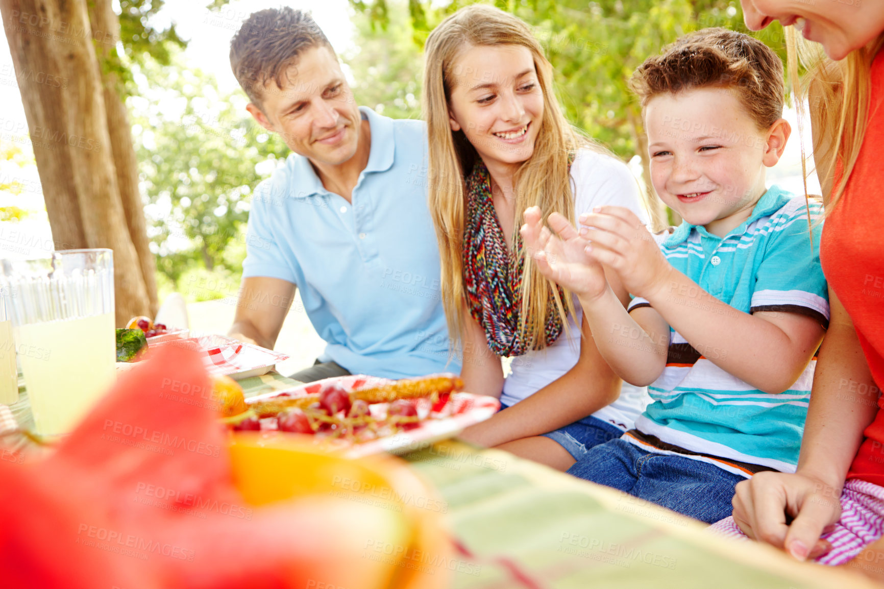 Buy stock photo Children, family and bonding with food, picnic and parents with siblings, nutrition or healthy in nature. Happy, woman and man with kids, vegan and fruit in weekend, fun and break in park or together