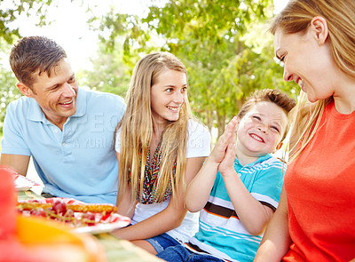 Buy stock photo Children, happy family and parents at picnic for lunch, party and eating fruits thanksgiving. Smile, food and people outdoor with mother, father and kids for celebration on summer holiday together
