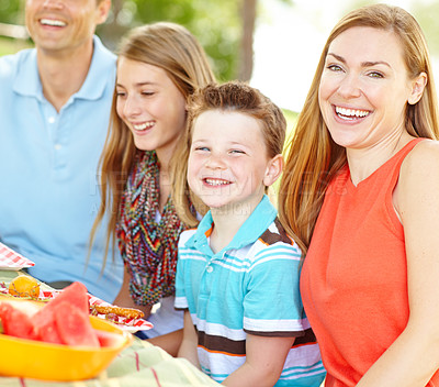 Buy stock photo Child, happy family and mother at picnic for lunch, laughing and eating fruits at thanksgiving. Smile, food and people outdoor with father, parents and kids for celebration on summer holiday together