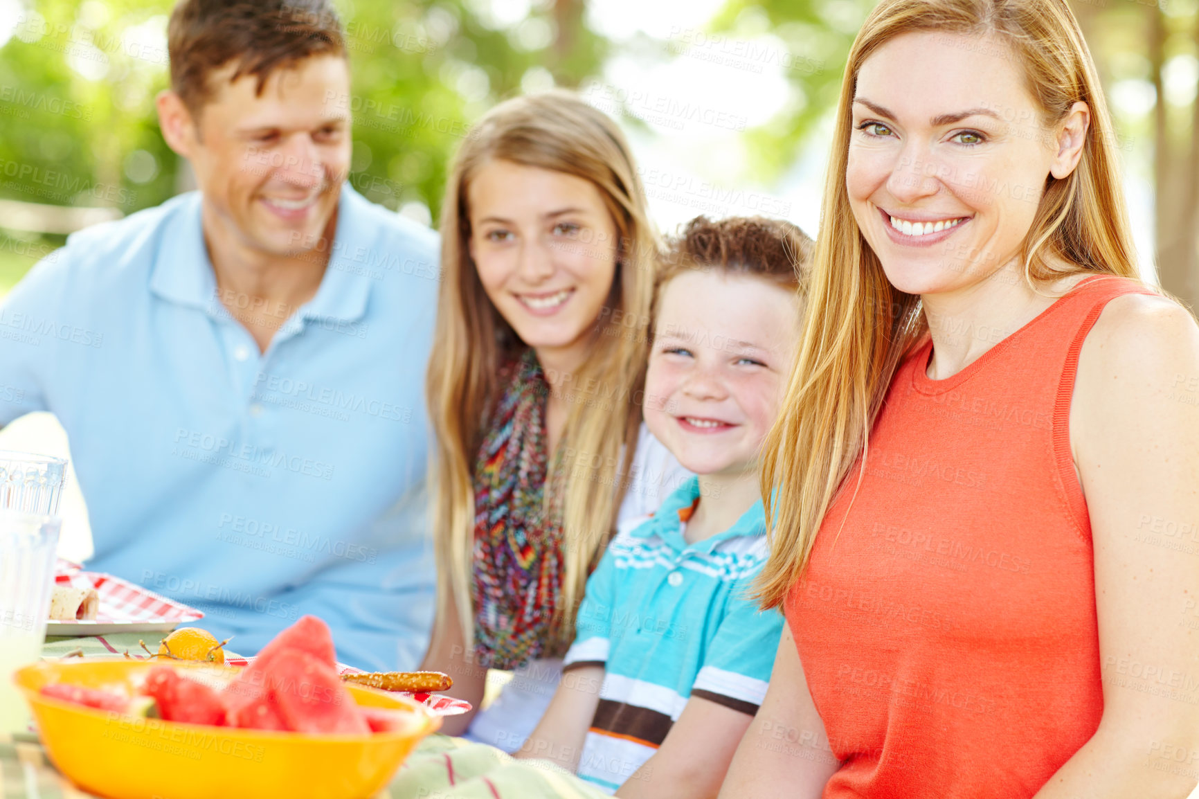 Buy stock photo Kids, happy family and mother at picnic for lunch, vacation and eating fruits at thanksgiving. Smile, food and people outdoor with parents, father and children to celebrate summer holiday together