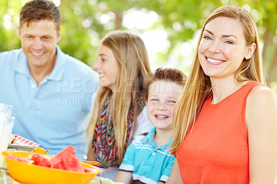 Buy stock photo Portrait, happy family and mother at picnic for lunch, vacation or eating fruits at thanksgiving. Smile, food and people outdoor with parents, father and children to celebrate summer holiday together