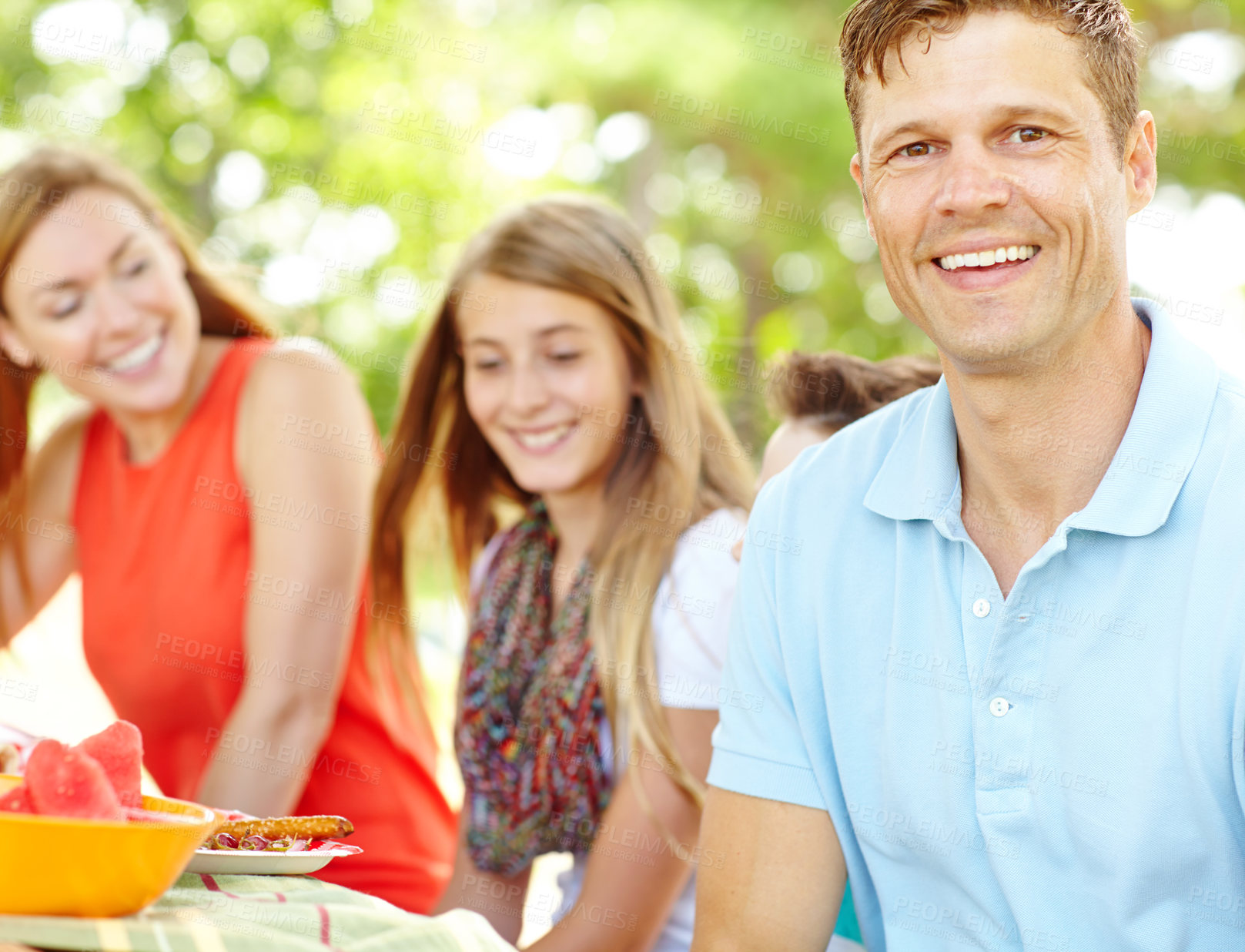 Buy stock photo Portrait, family and bonding with dad, picnic and parents with siblings, nutrition or healthy in nature. Happy, woman and man with kids, vegan and fruit in weekend, fun and break in park and together