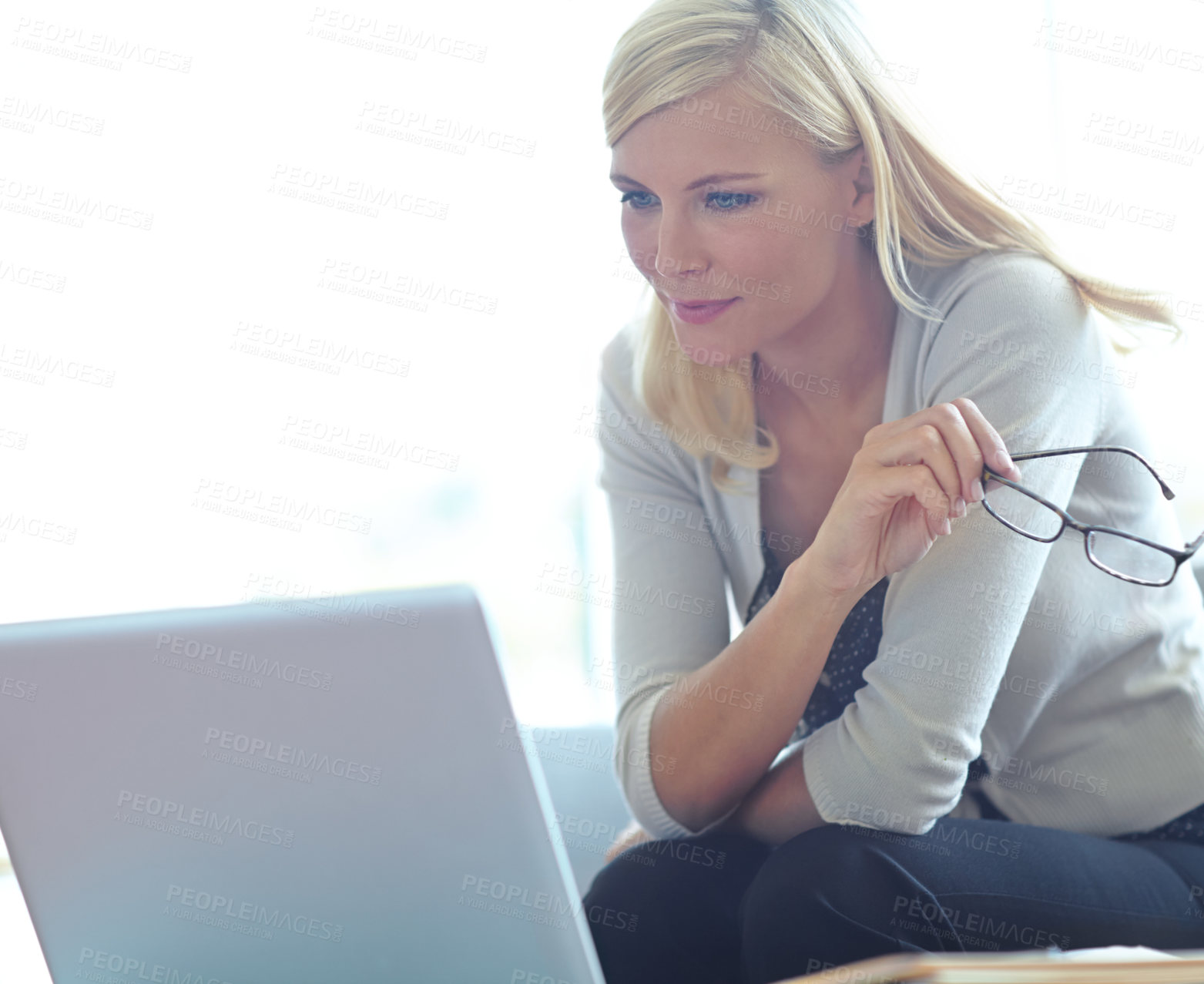 Buy stock photo Shot of a beautiful business woman looking at her laptop 