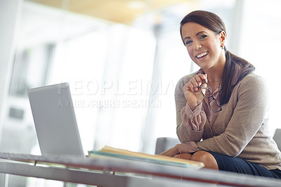 Buy stock photo Portrait of a laughing brunette business woman in her office with her laptop and paperwork in front of her with copyspace
