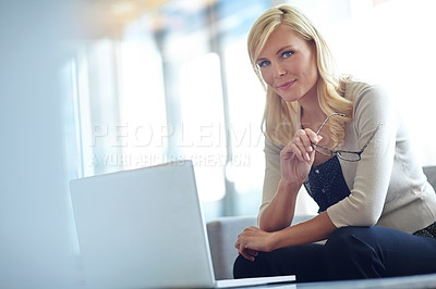 Buy stock photo Portrait of a beautiful business woman sitting behind her laptop and holding her eye glasses with copyspace