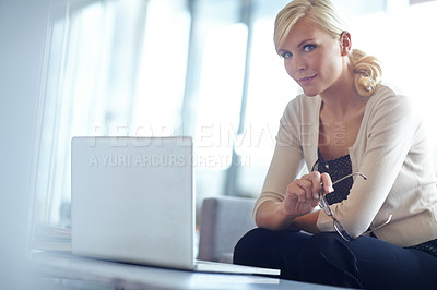 Buy stock photo Portrait of a beautiful business woman sitting behind her laptop and holding her eye glasses with copyspace