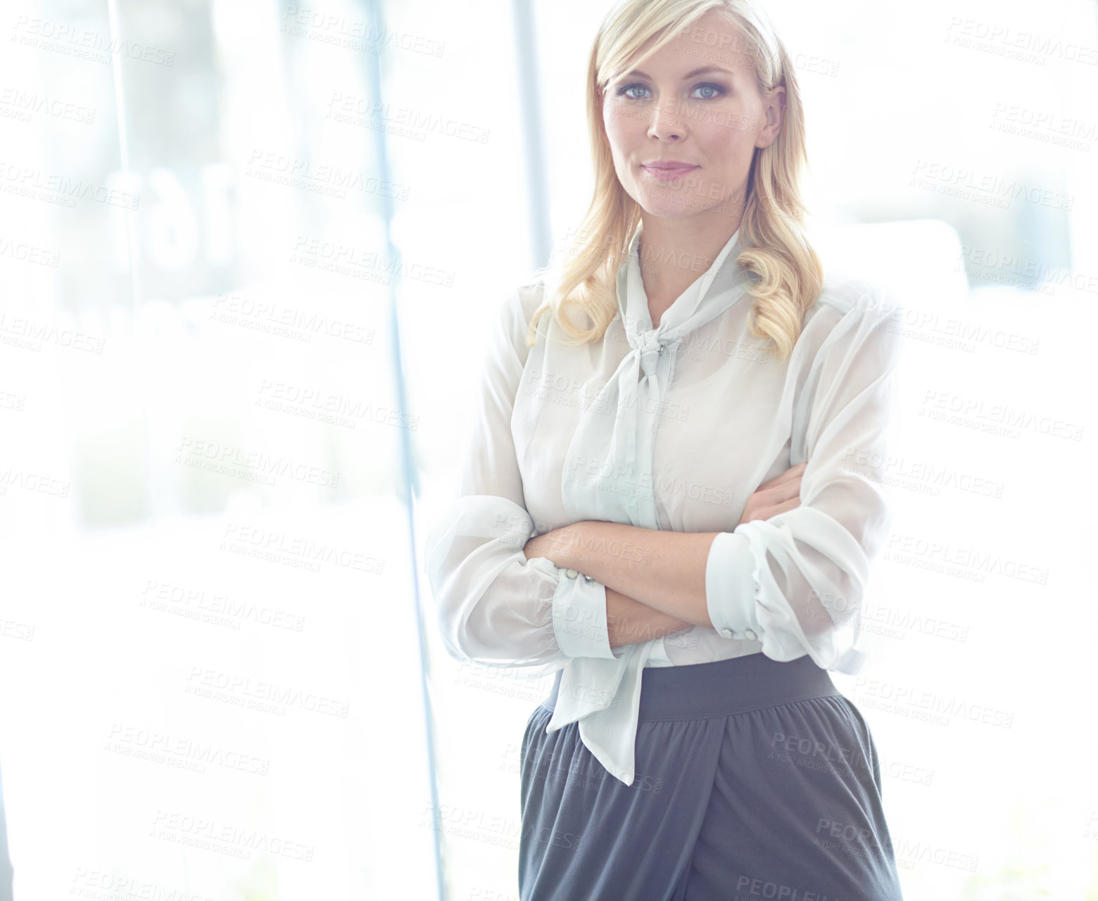 Buy stock photo Portrait of a stern looking business woman with her arms folded and copyspace