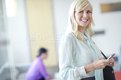 Buy stock photo Candid shot of smiling business woman holding her phone and walking in to work with copyspace
