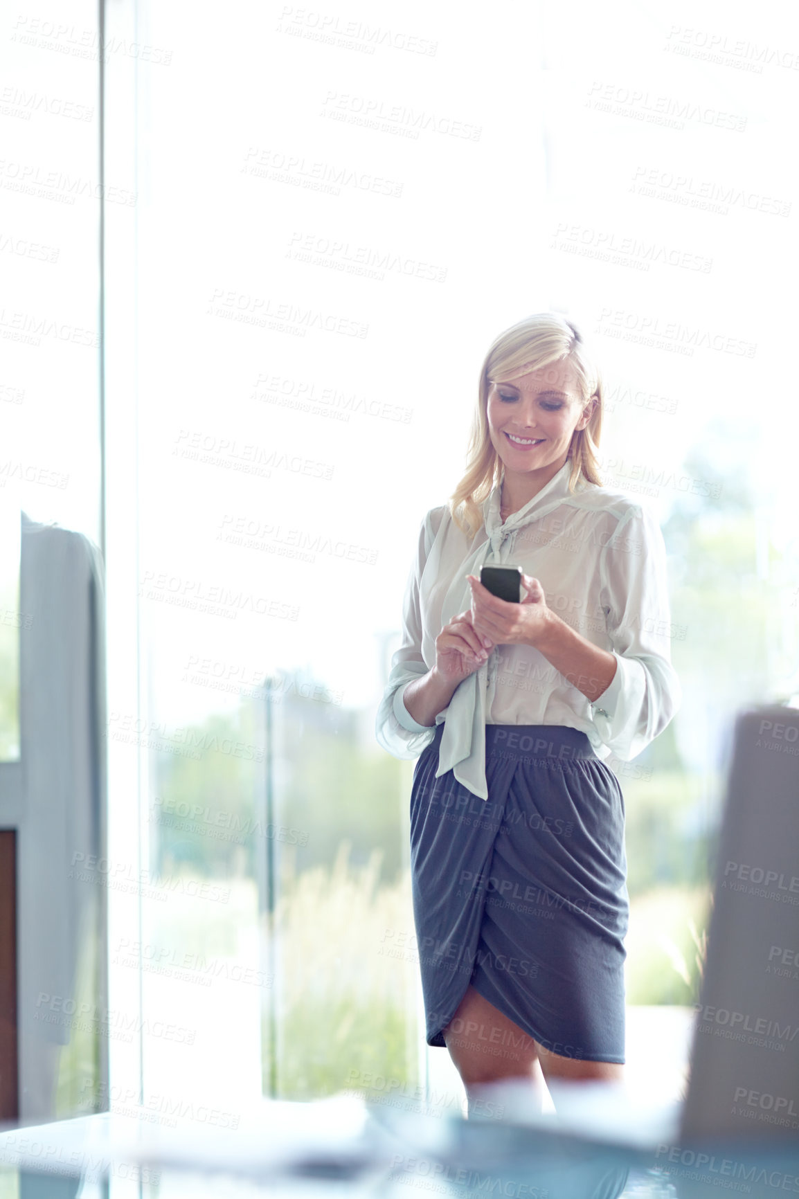 Buy stock photo Business woman, smartphone and texting in office with smile for notification, email or contact at company. Person, phone and scroll on mobile app for networking, chat and reading at insurance agency