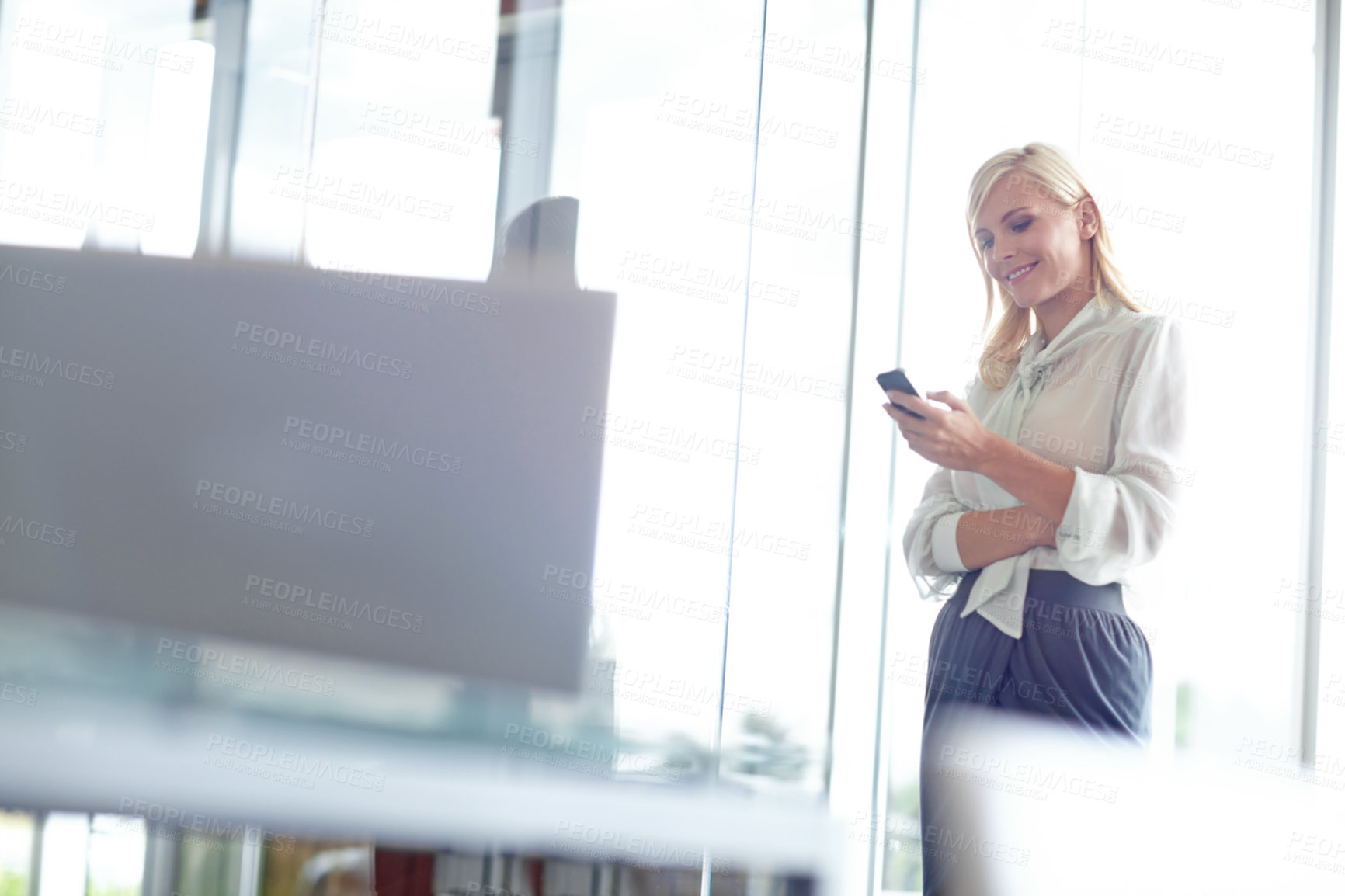 Buy stock photo Woman, smartphone and reading in office with smile for notification, email or contact at company. Business person, phone and scroll on mobile app for networking, chat and texting at insurance agency