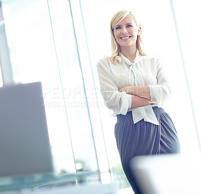 Buy stock photo Portrait of a smiling business woman  with her arms folded  standing in her office with copyspace