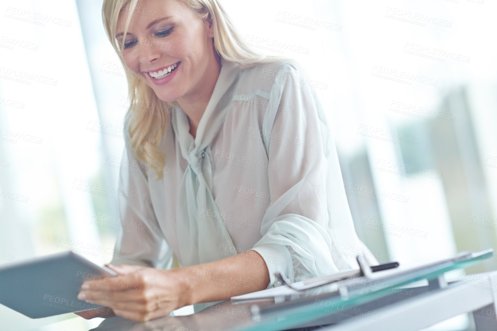 Buy stock photo Business, woman and tablet at desk in office for stock market, research or reading equity report. Financial, broker and happy with technology for finance forecast, prediction or update on share price