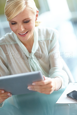 Buy stock photo A beautiful corporate woman looking at her touchscreen