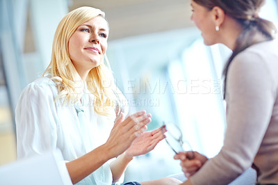 Buy stock photo Two corporate women in discussion at the office