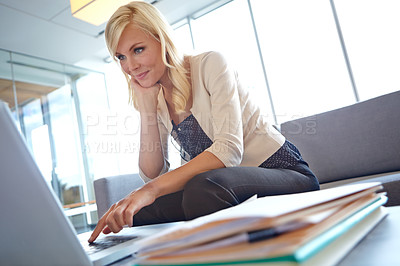 Buy stock photo A beautiful blonde woman working on her laptop at the office