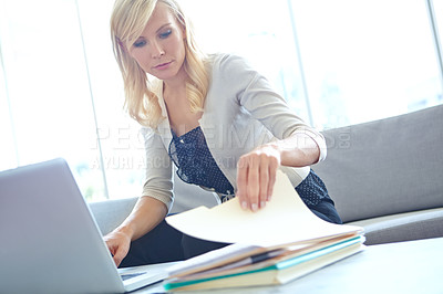Buy stock photo A beautiful blonde woman working on her laptop at the office - Copyspace